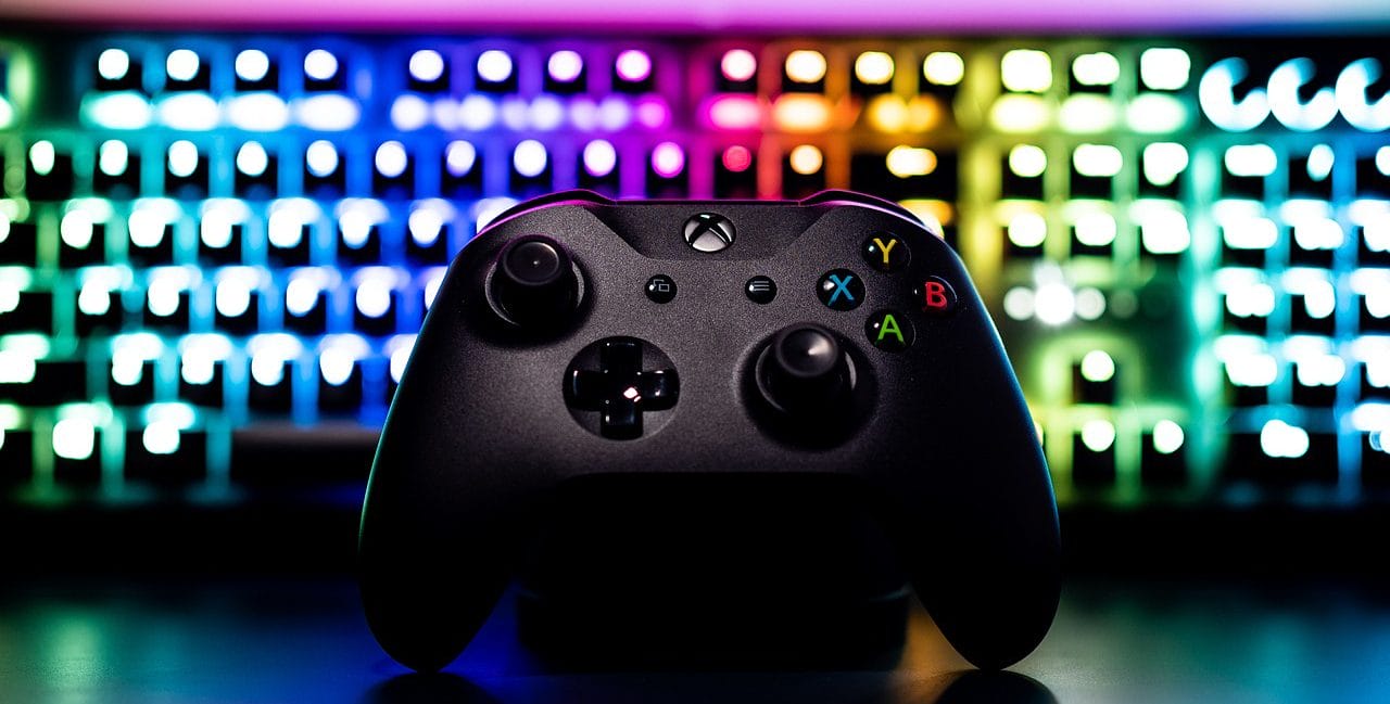 Xbox Controller In Front Of An Rgb Keyboard.