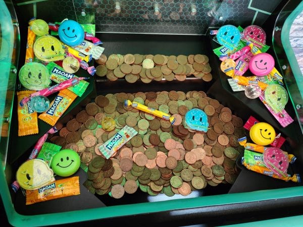 Coin Push Machine Filled With Coins And Prizes